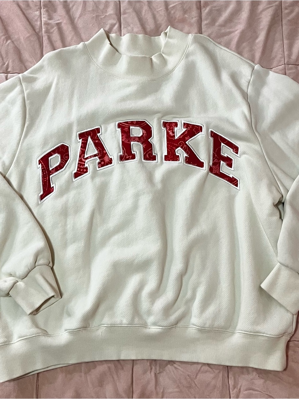 'PARKE' Varsity Mock-neck Sweatshirt with Bandana patterned red logo.